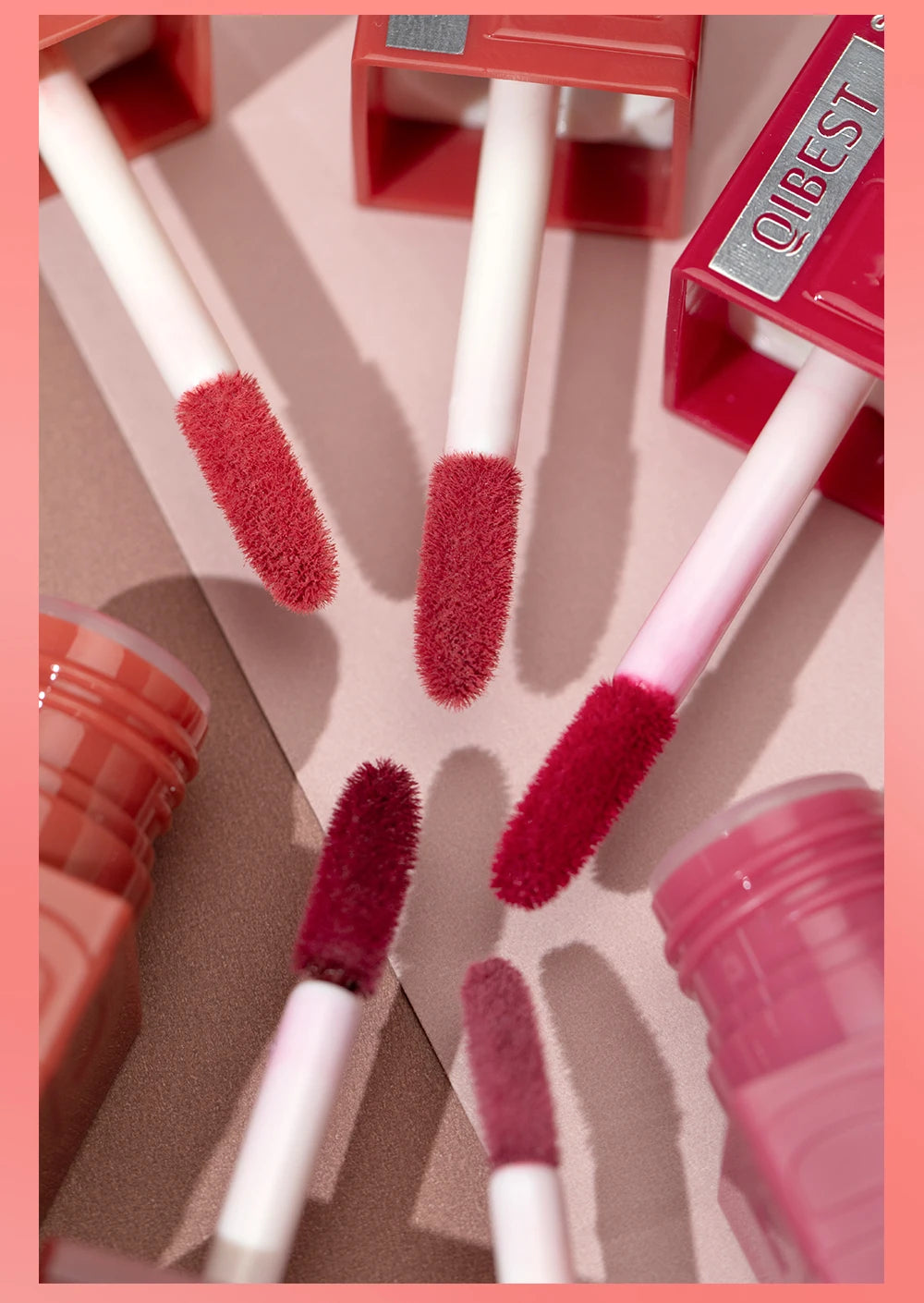QIBEST moisturizing liquid lipstick wands in various red shades with a glossy, long-lasting watery lip glaze finish.