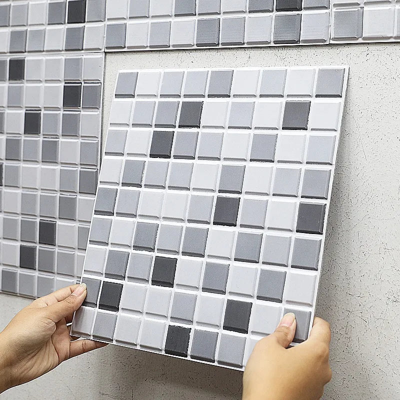 Peel-and-stick backsplash tiles with white and gray tile-grid pattern on adhesive sheet