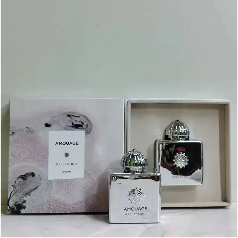 Amouage Reflection Woman EDP: Luxury metallic square bottles with silver dome caps in branded gift box, floral scent.