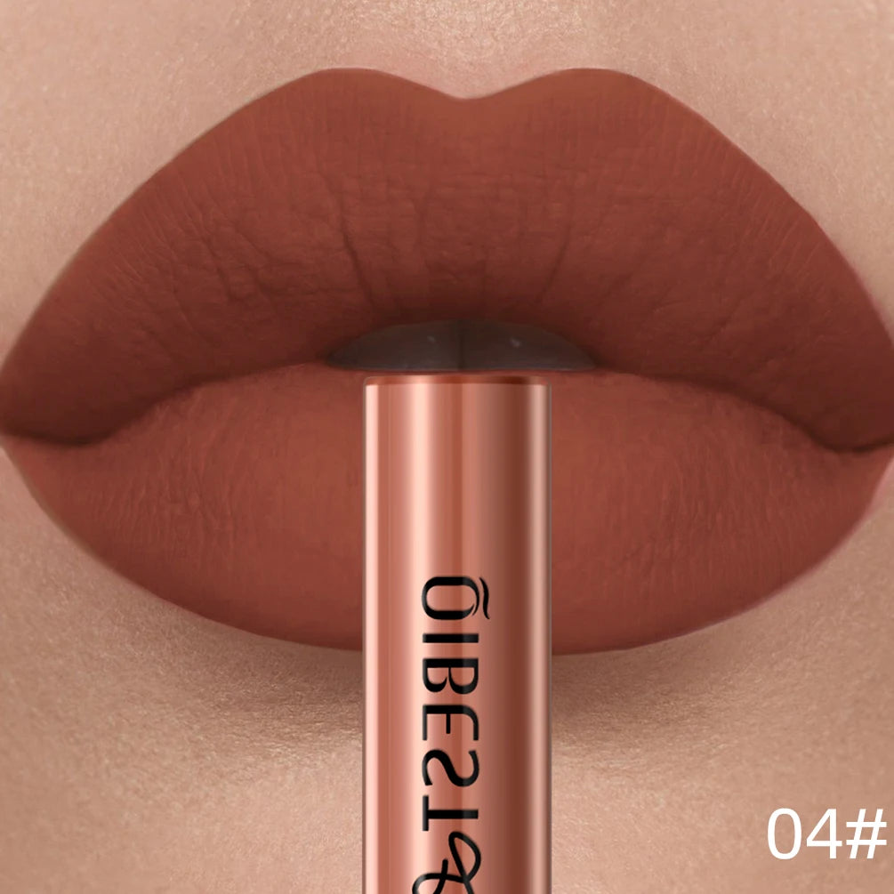 QIBEST velvet matte liquid lipstick in a rich, long-lasting terracotta red shade applied on lips with product tube.