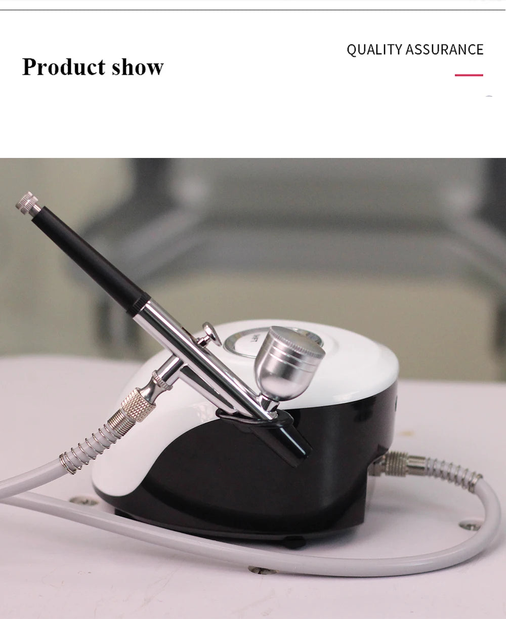 Portable black and white airbrush compressor with a metal spray gun and hose, suitable for facial or nail art.