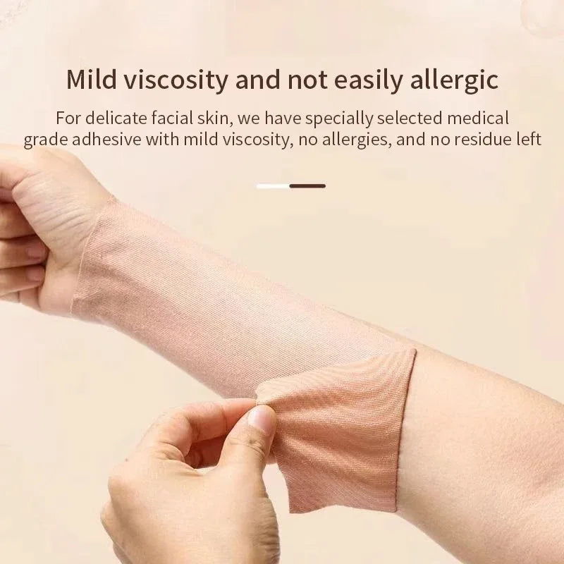 A beige cotton kinesiology lifting tape applied to an arm, being gently peeled back by a hand.