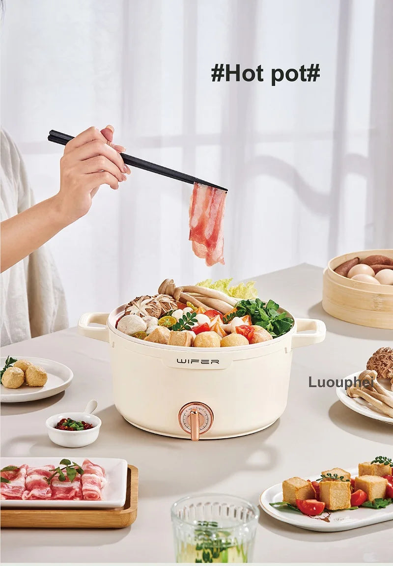 Beige electric hot pot steamer with bamboo lid, front power knob, and serving pot