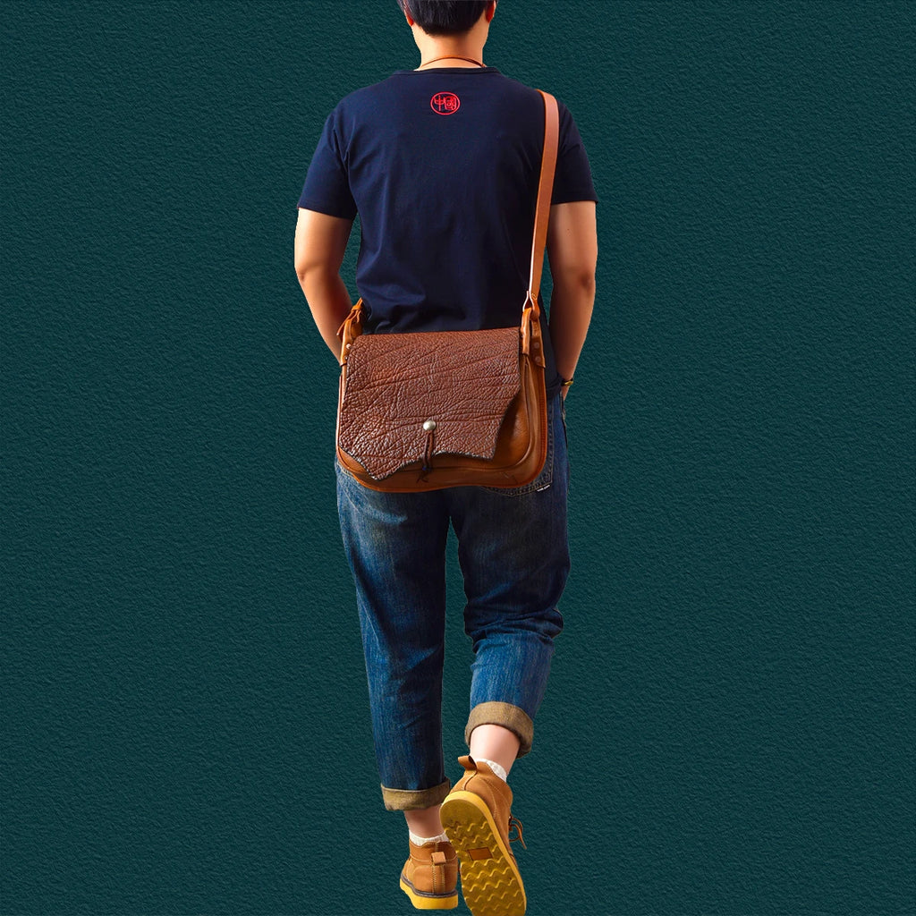 Vintage brown genuine leather messenger bag with textured flap and crossbody strap, handmade designer style.