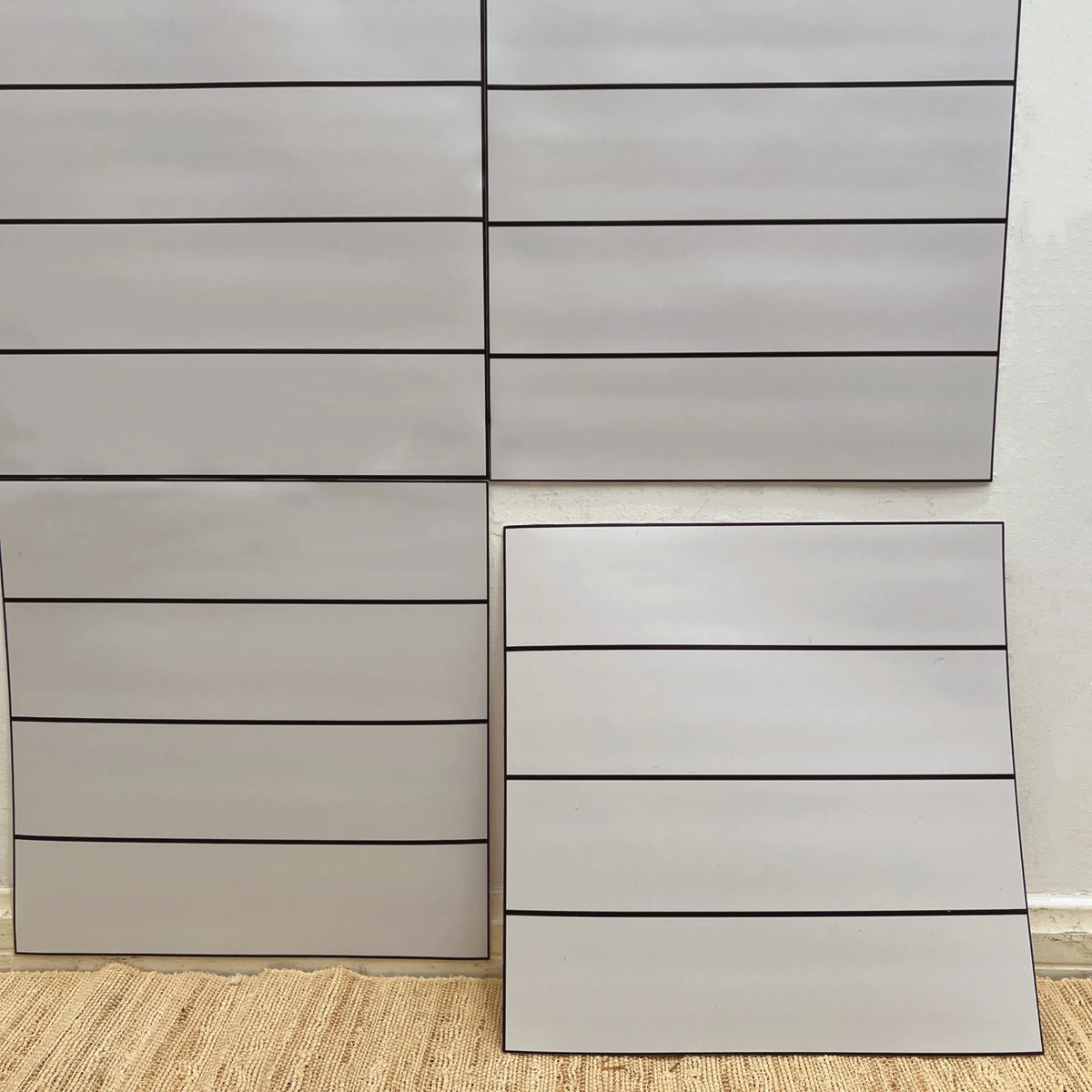 Peel-and-stick backsplash tiles in light beige with horizontal strip pattern