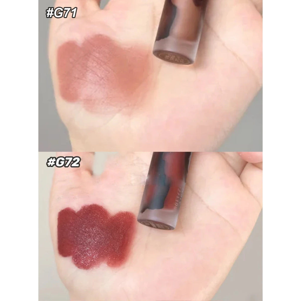 Girlcult Love Whisper velvet matte lip stain swatches in shades #G71 nude and #G72 deep red on hand for soft-focus finish.