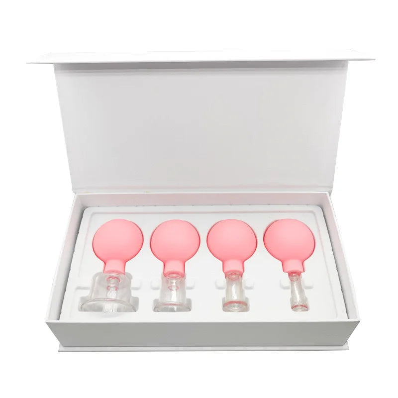 Set of four pink rubber-topped glass vacuum facial cupping tools arranged in a white presentation box.