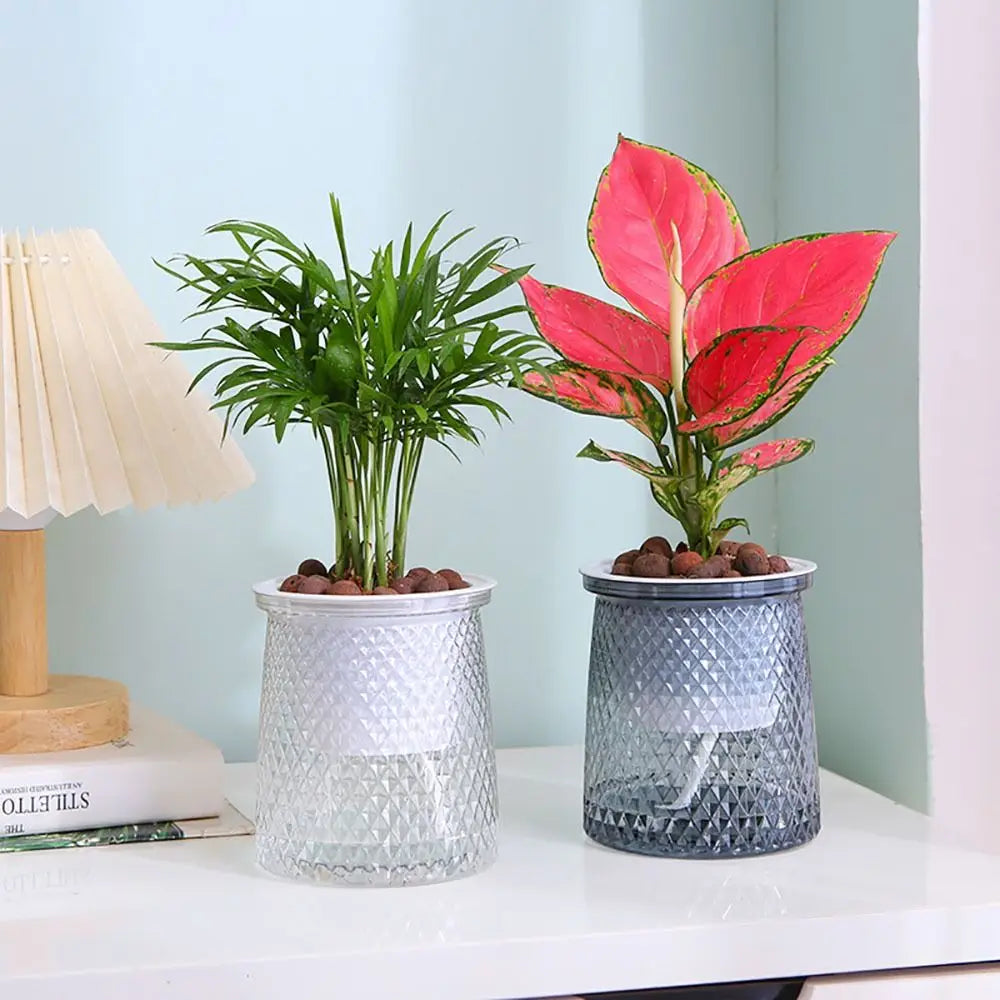Two self-watering plastic planters, textured white and gray pots with water reservoir tops