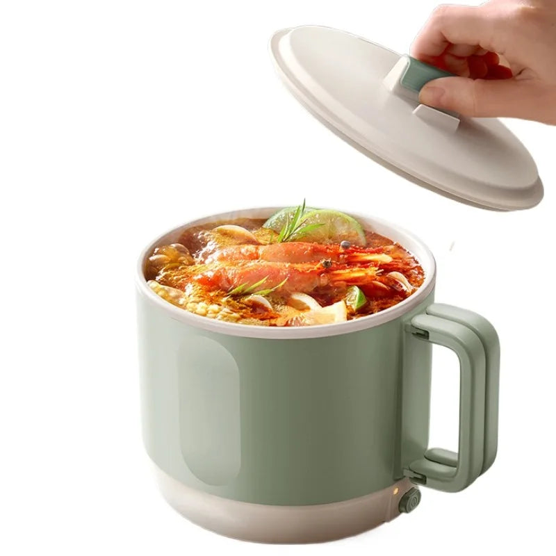 Electric hot pot cooker with mint-green pot and clear lid releasing steam