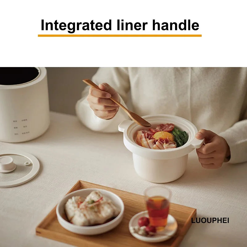 White electric rice cooker with integrated liner handle and open inner pot