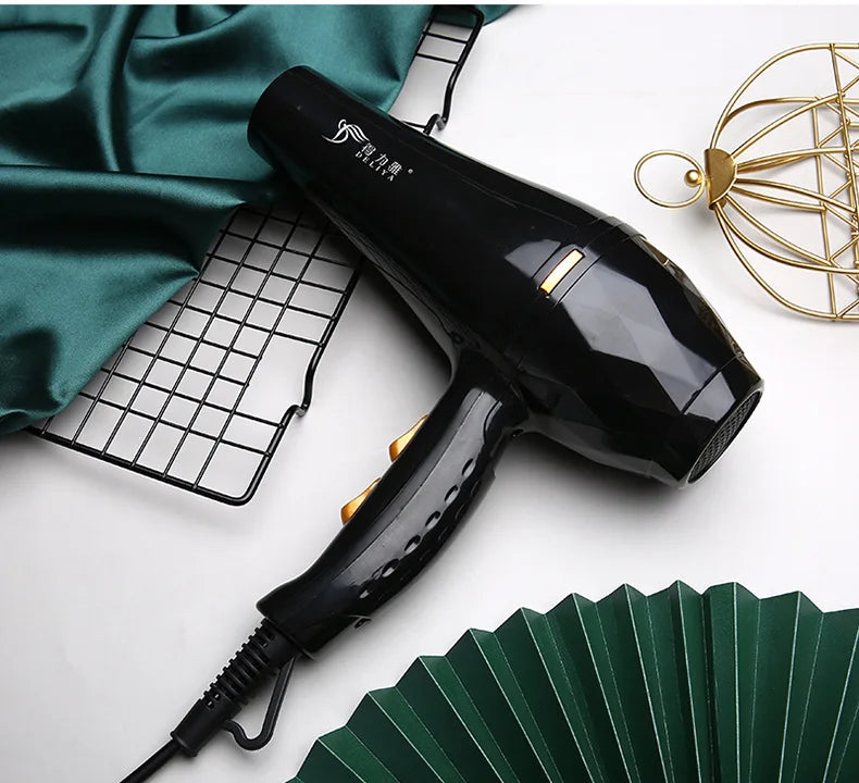 Black professional hair dryer with gold controls and sleek design for quick-drying salon results at home.