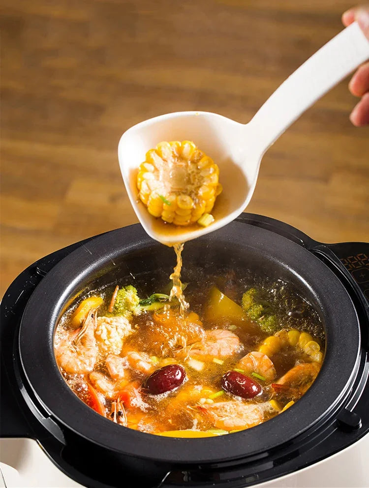 6L non-stick stir-fry cooker pot with food simmering as broth is poured
