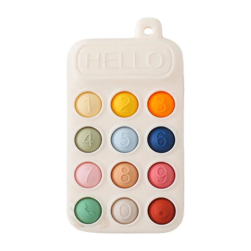 Off-white silicone teething toy for baby with colorful number buttons for relief.