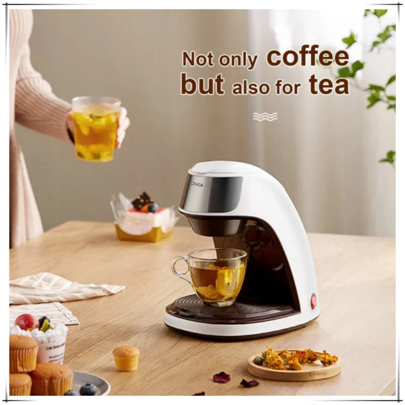 White and brown compact single-serve coffee and tea maker on a table with a brewed glass of tea.