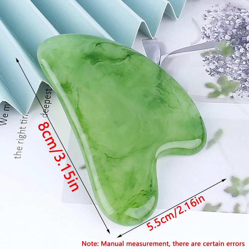 Green heart-shaped jade gua sha stone for facial massage, measuring approximately 8cm by 5.5cm.