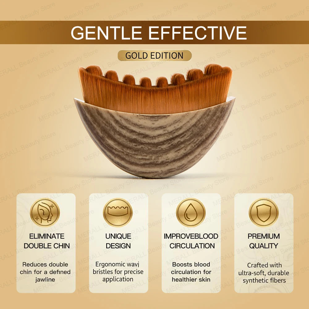 Face massager brush with a wood-grain handle and wavy, brown synthetic bristles. Gold edition text in the background.
