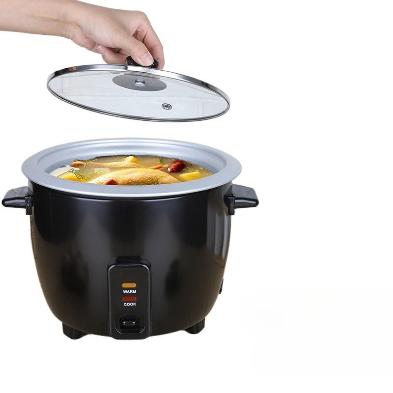 Mini electric rice cooker on counter with clear glass lid and black cooking pot