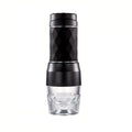 Portable black diamond-patterned manual coffee maker with a clear glass base, isolated on a white background.