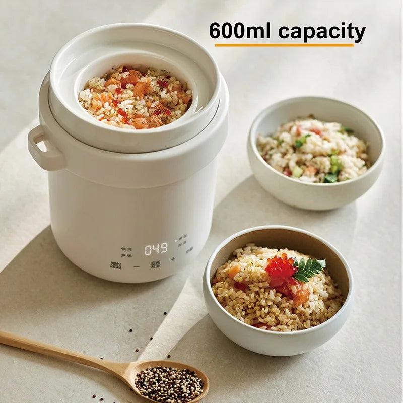 Smart white 600ml electric rice cooker pot with lid; serving bowls show cooked grains.