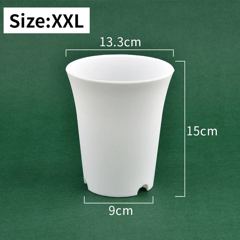 White plastic nursery seedling pot, tall conical shape with drainage holes