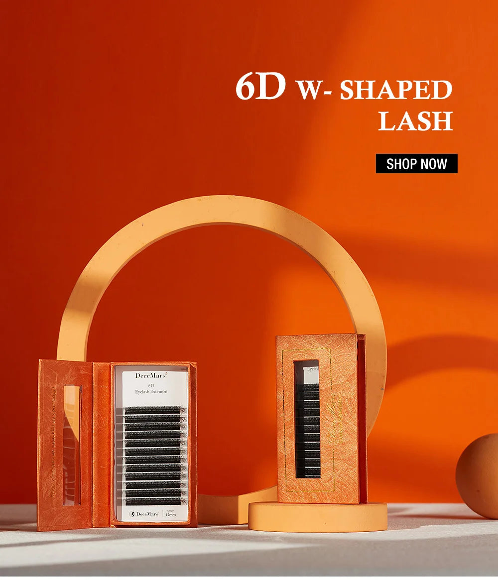Two boxes of black DeceMars 6D W-shaped eyelash extensions against an orange background with a circular display stand.