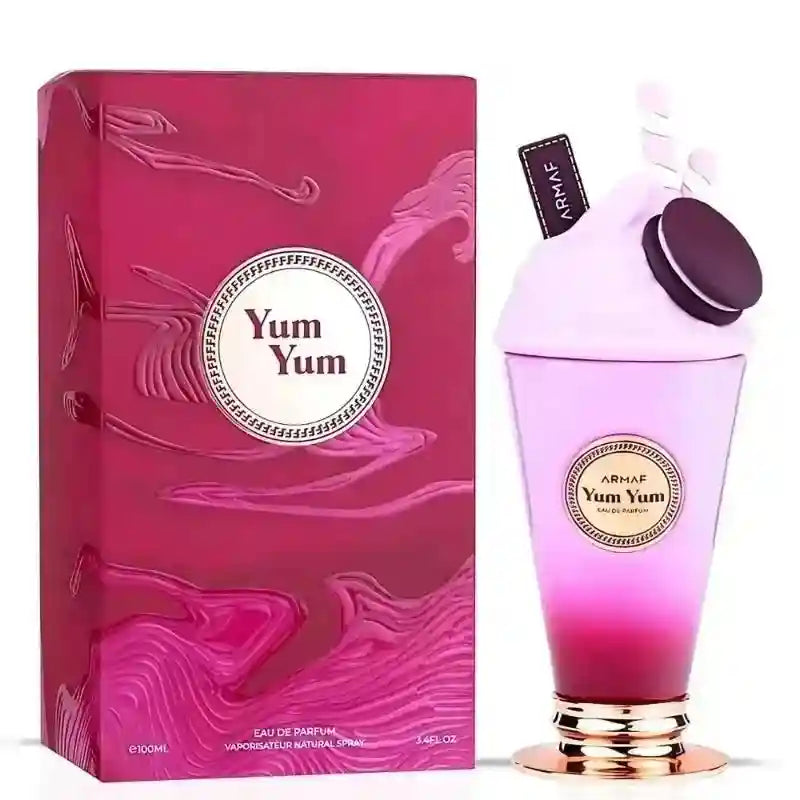 Yum Yum eau de parfum, a 100ml milkshake-shaped bottle with a pink cap and cookie topper, next to its textured box.