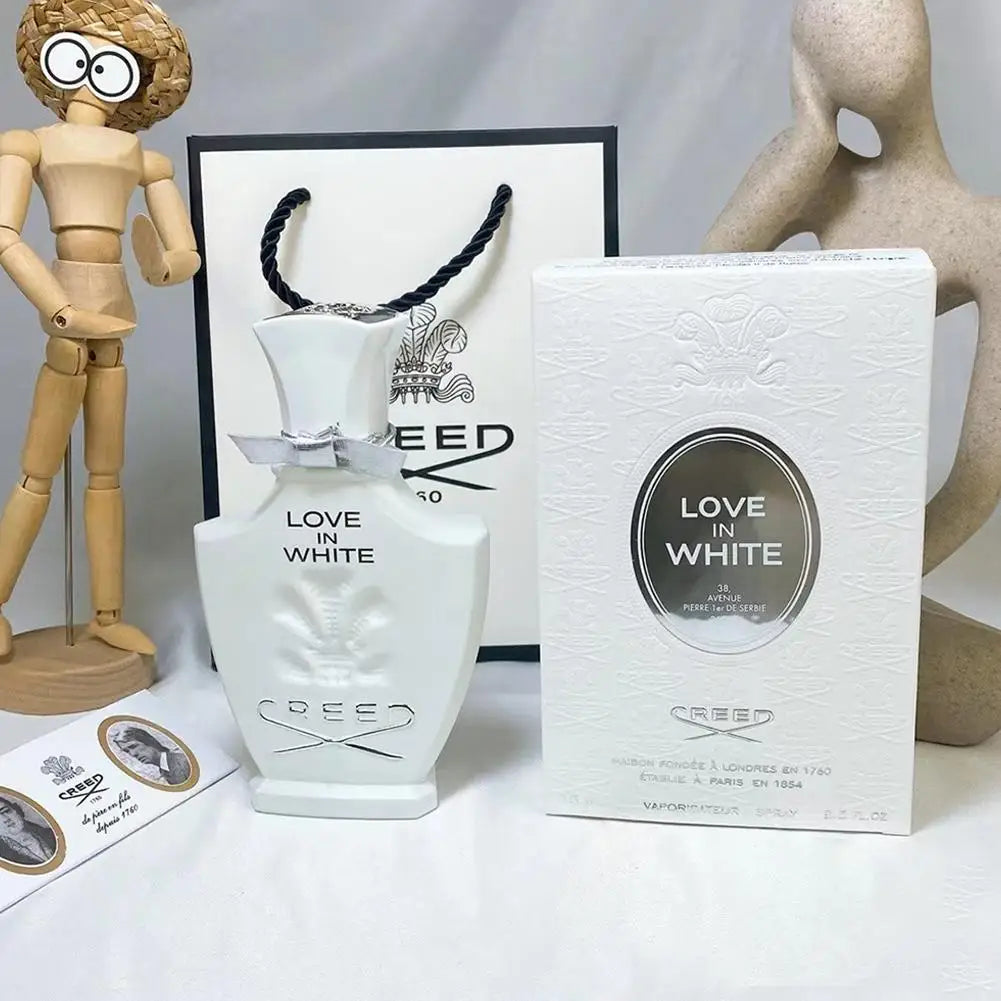 Creed Love In White Eau de Parfum for women, elegant white glass bottle with silver ribbon, floral designer spray.