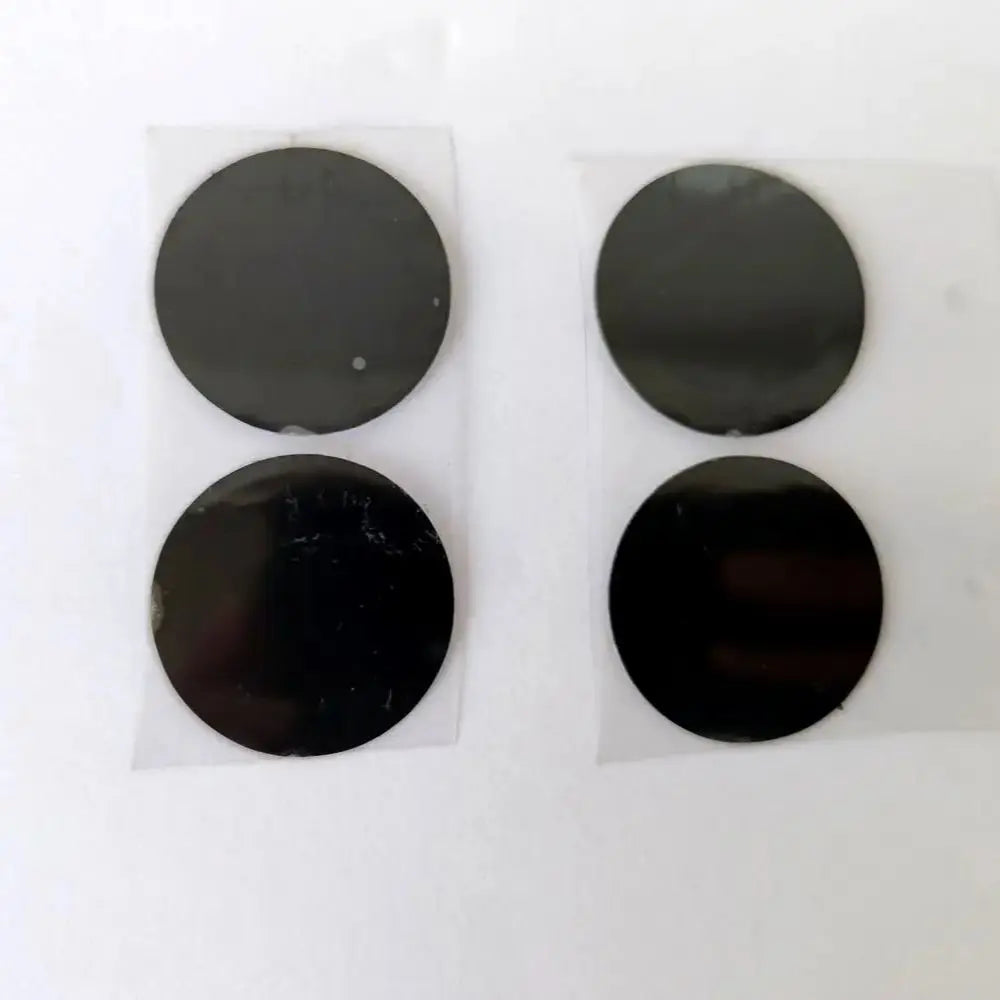Four 28mm diameter round black replacement film stickers for Vmax HIFU beauty machine cartridges on clear backing.