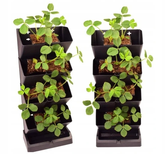 Dark grey vertical modular planter with four stacked compartments and base, holding herbs