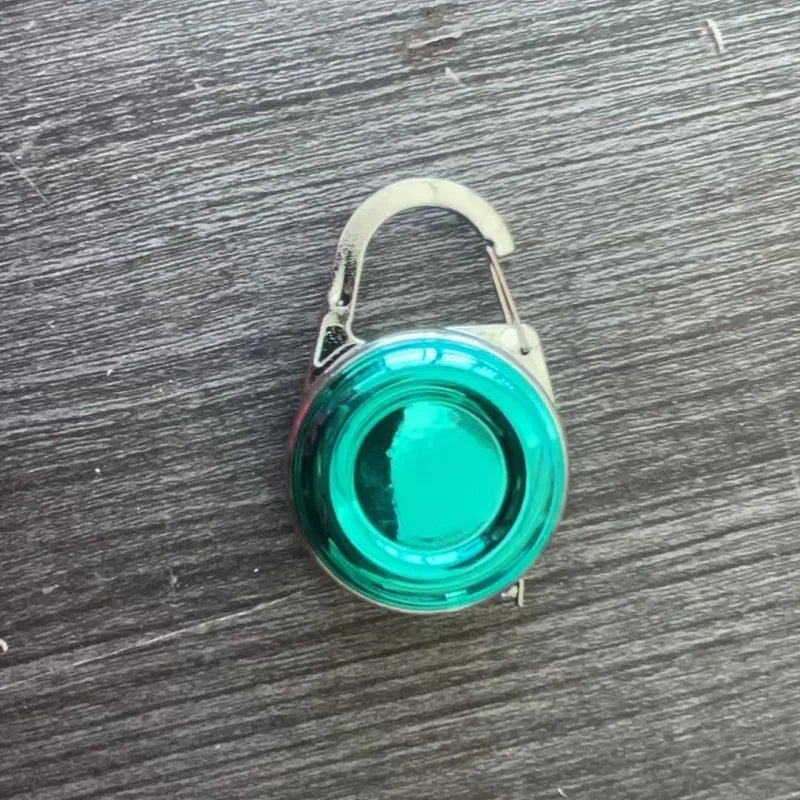 Green round bubble vial level tool with arched handle and metallic base