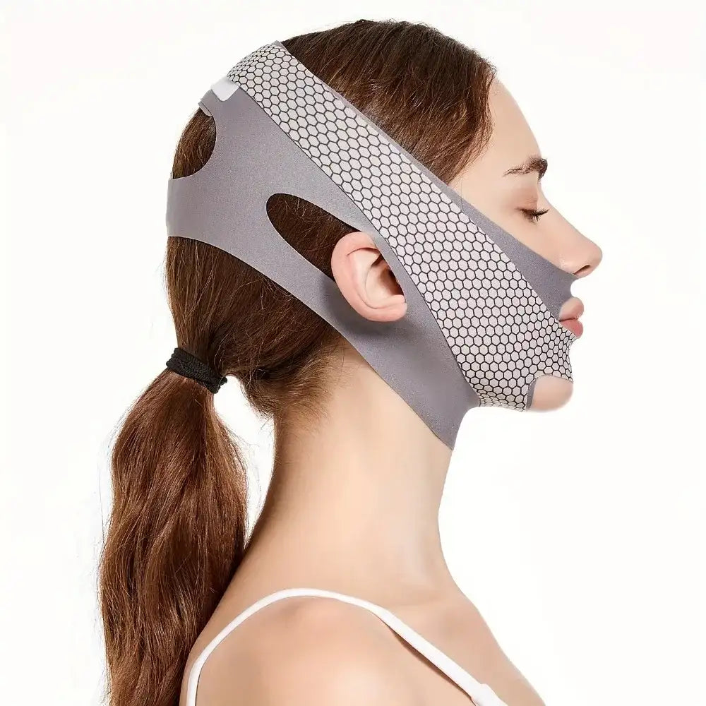 Side profile of a person wearing a grey, honeycomb-patterned V-line face slimming lifting belt.