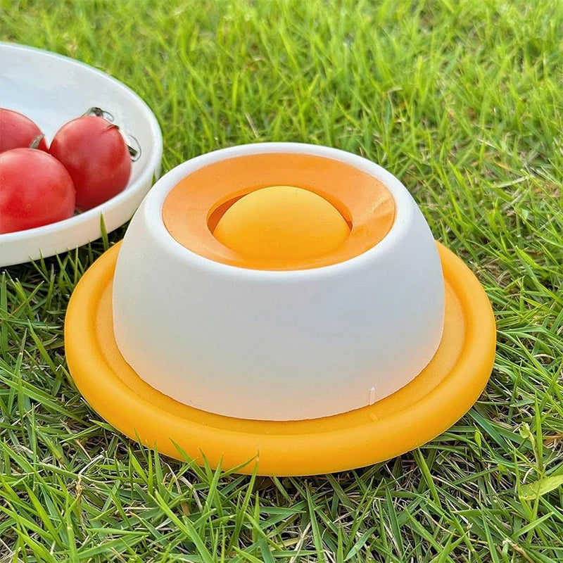Yellow and white interactive dog and cat lick mat slow feeder for dental health and mental enrichment on grass.