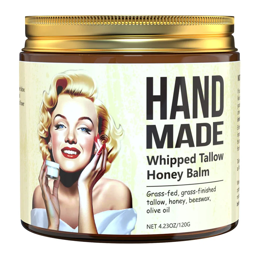 Amber jar of "Hand Made Whipped Tallow Honey Balm" with a gold lid and a vintage illustration of a blonde woman.