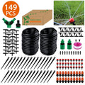 Garden hose irrigation kit with black coils, green connectors, and drip stakes in box