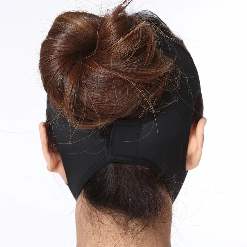 Back view of a person wearing a smooth, black elastic V-line face slimming bandage strap over their chin and head.