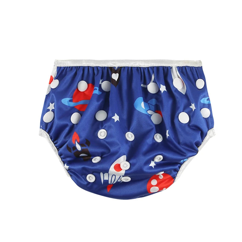 Reusable cloth swim diaper with adjustable snaps in a blue outer space rocket and planet print for baby care.