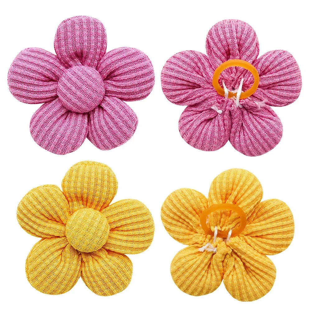 Pink and yellow flower hair bows with rubber bands for small dogs, cats, and pet grooming accessories.