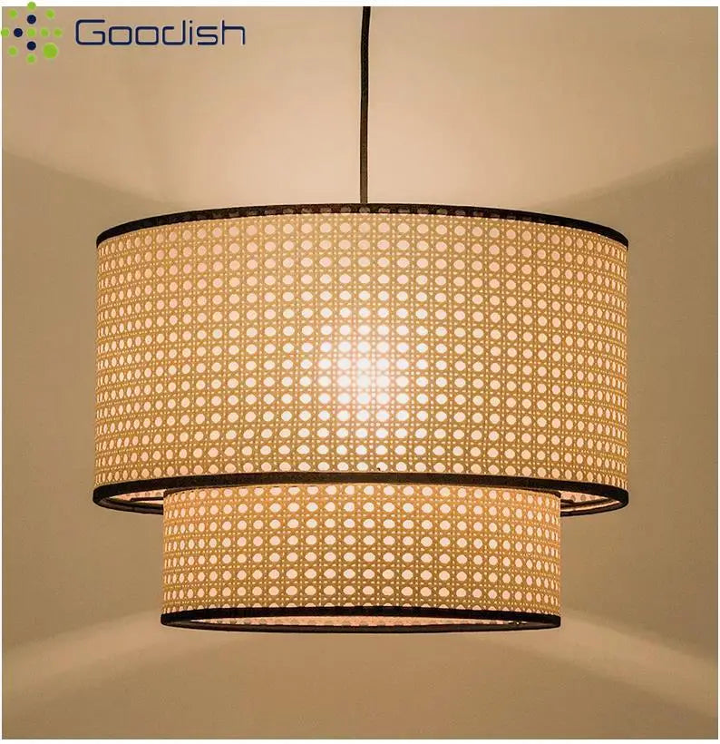 Two-tier cylindrical pendant light with beige rattan mesh shade and black trim for overhead interior lighting.