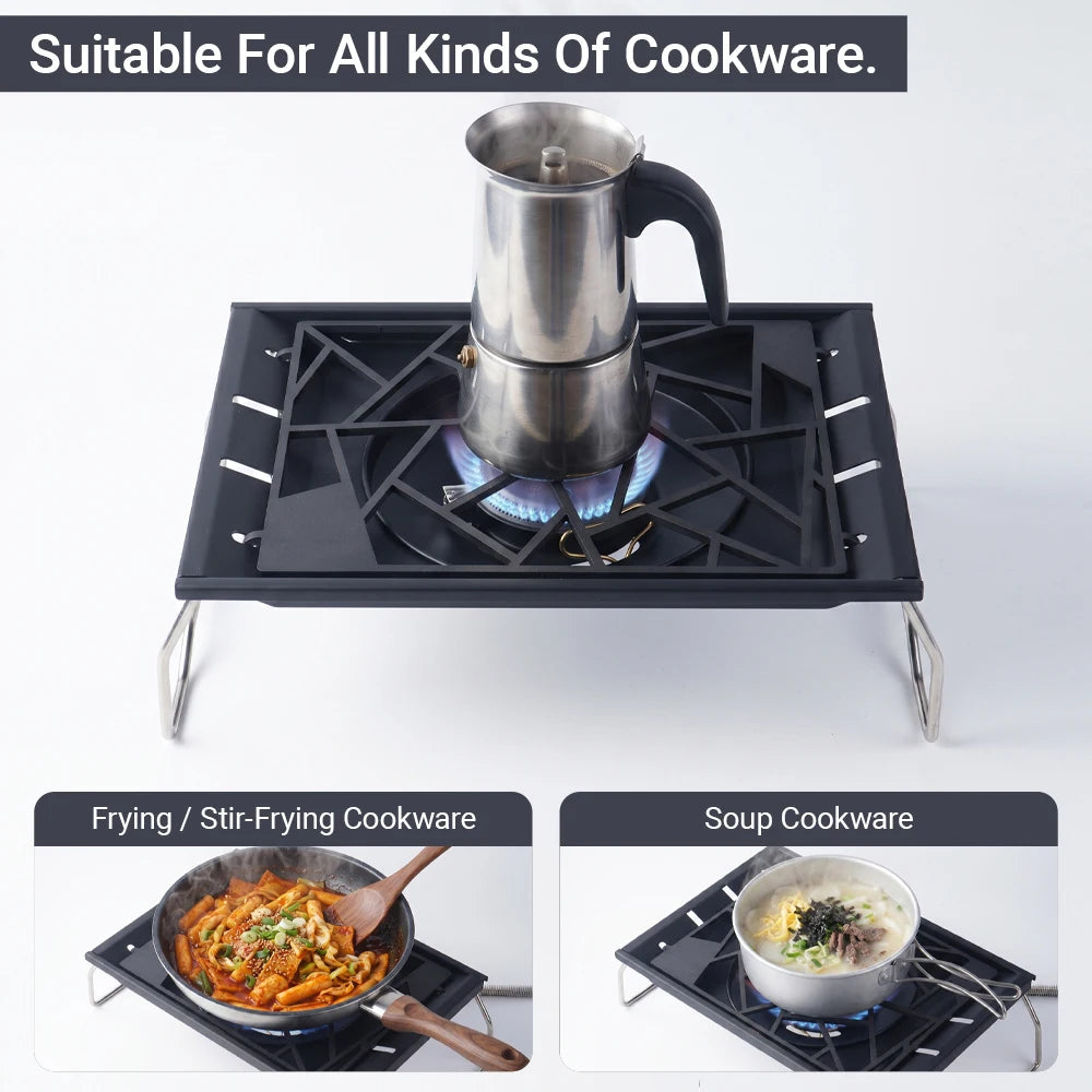 Tabletop camping stove with kettle on black burner grate and foldable legs