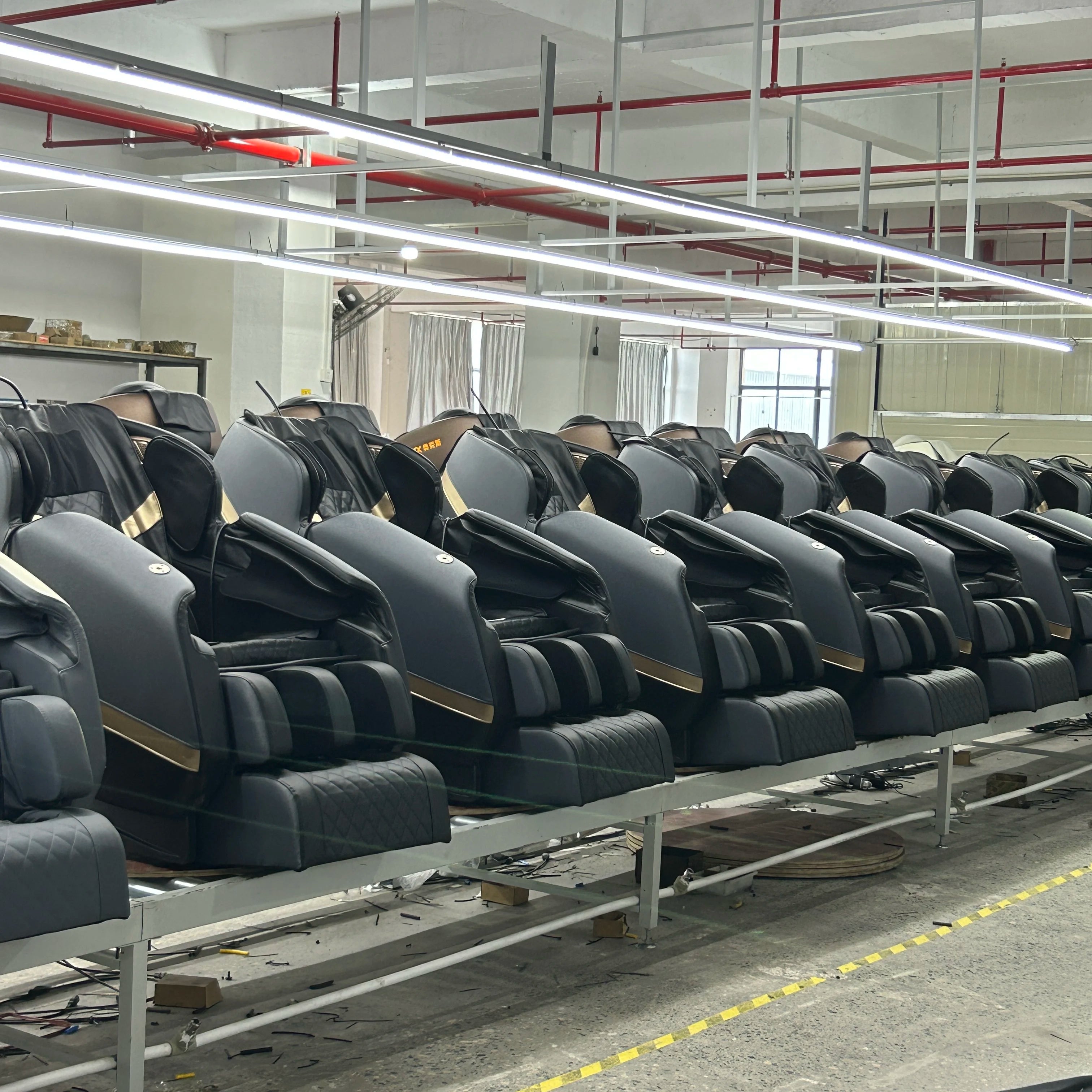 Gray shiatsu massage chairs with cushioned back and arm pads, side view row