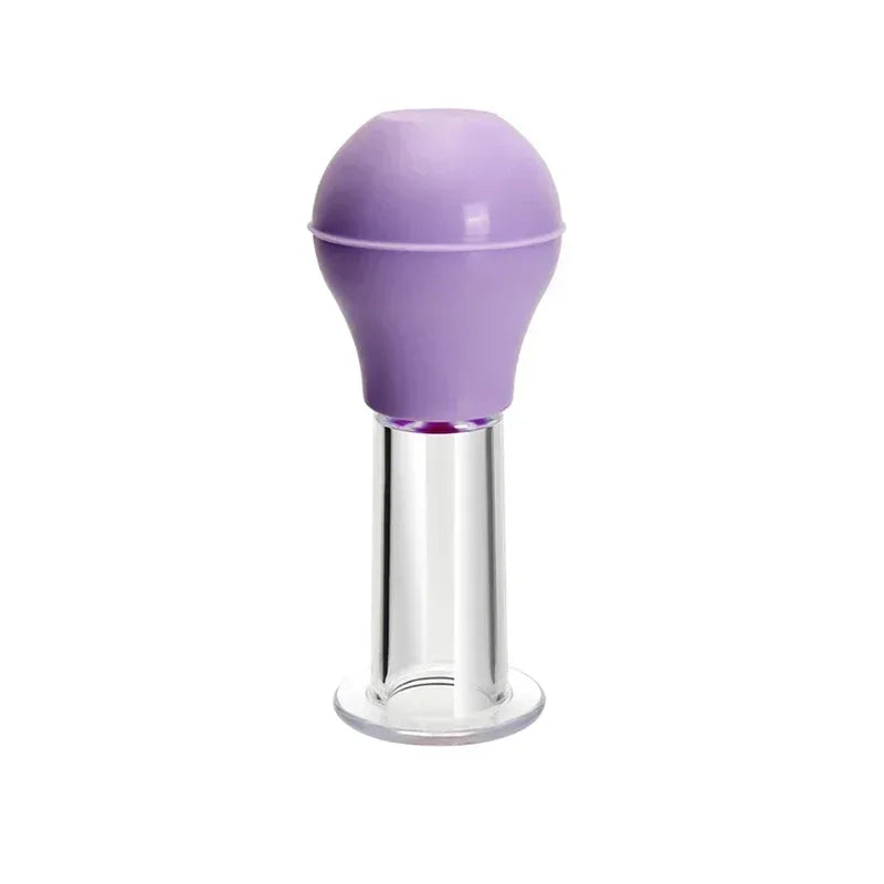 A facial massage cupping tool with a lavender rubber bulb top and a clear, cylindrical base.