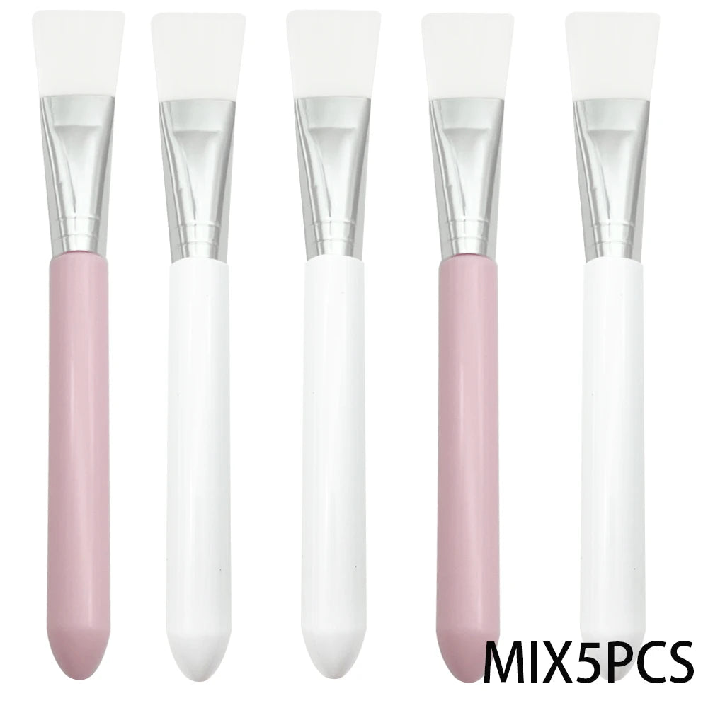 Five facial mask brushes with white silicone heads, silver ferrules, and alternating pink and white handles.