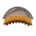 Curved facial brush with a grey wood-grain handle and soft, dense yellow-to-brown ombre bristles.