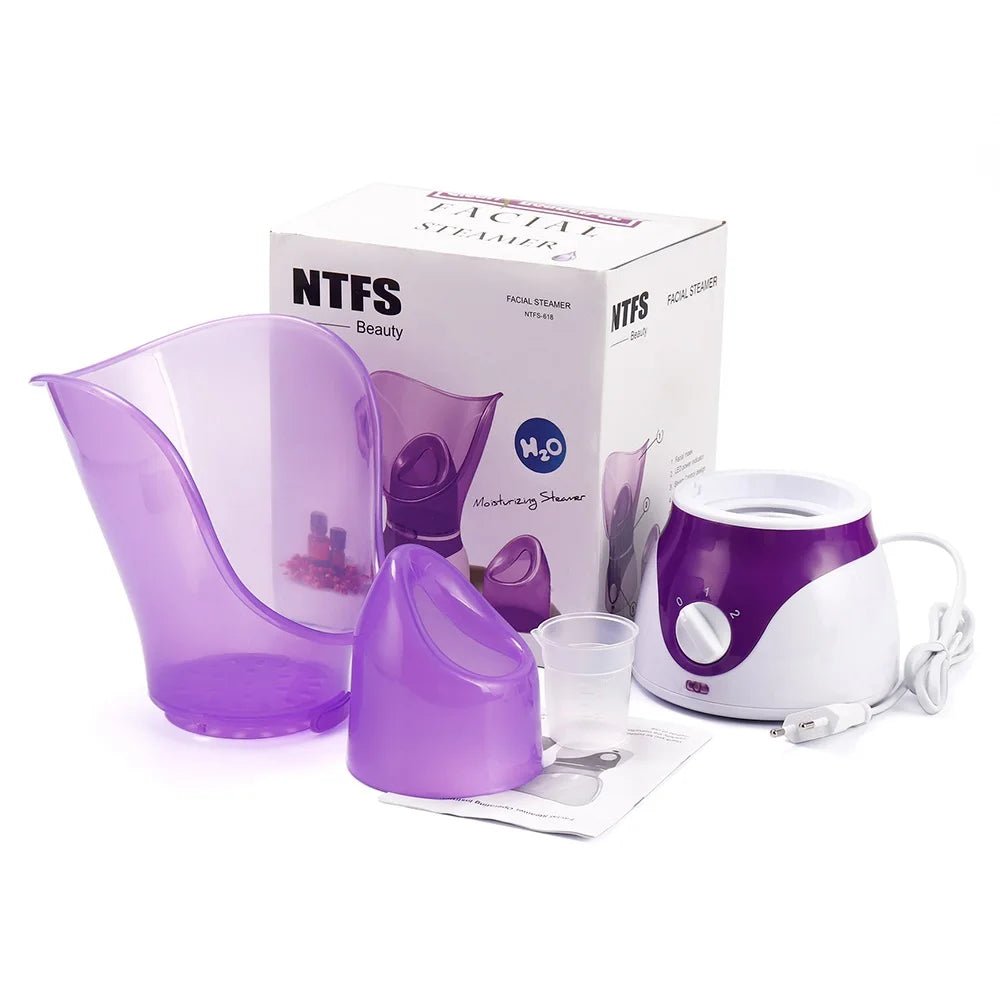 Purple home facial steamer kit with heating sprayer, pore cleaner mask, measuring cup, and box for skin moisturizing.