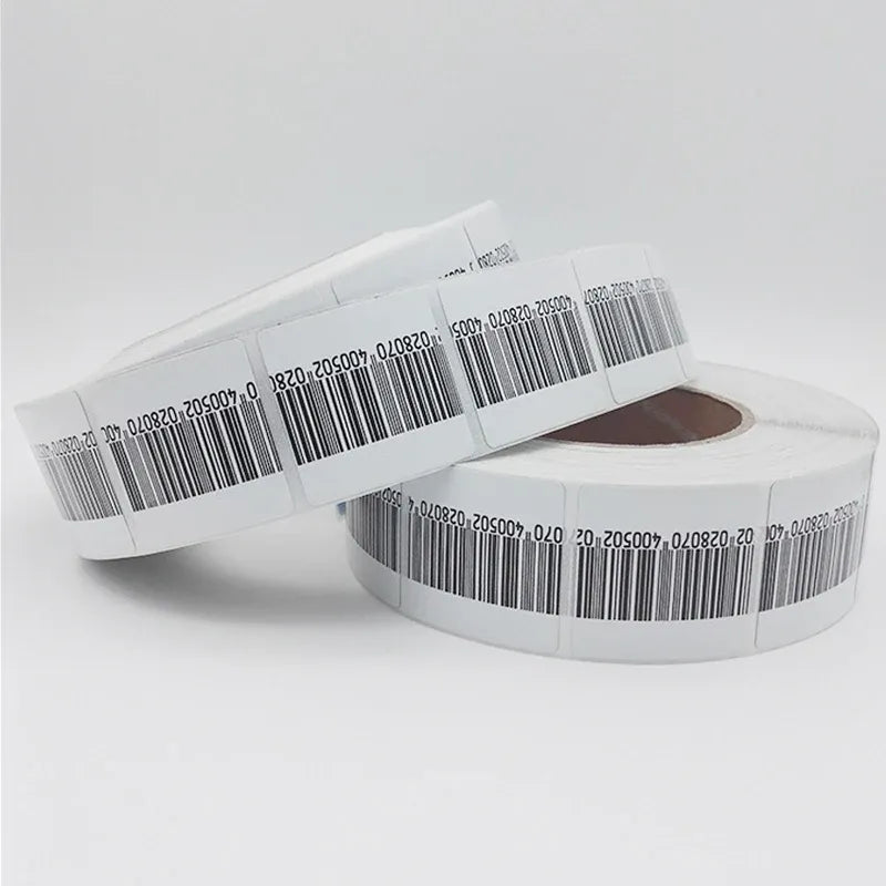 White RF EAS barcode soft label rolls, showing black barcode labels on tape