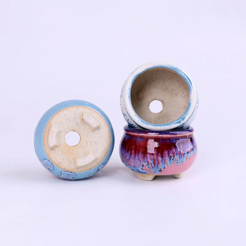 Mini ice-crack ceramic flowerpots shown from bottom, blue and burgundy glazed pair