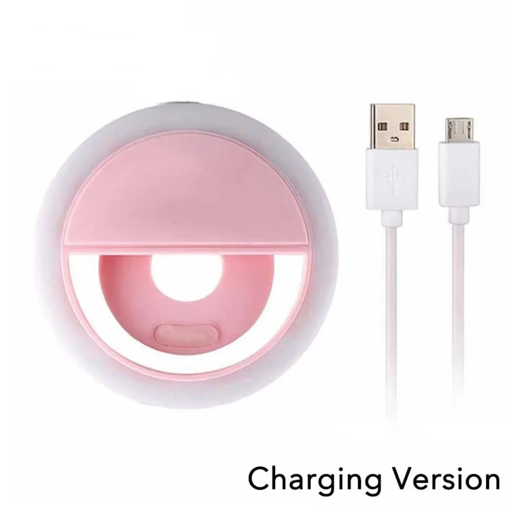 Pink circular clip-on LED ring light for smartphones with an included white USB charging cable.