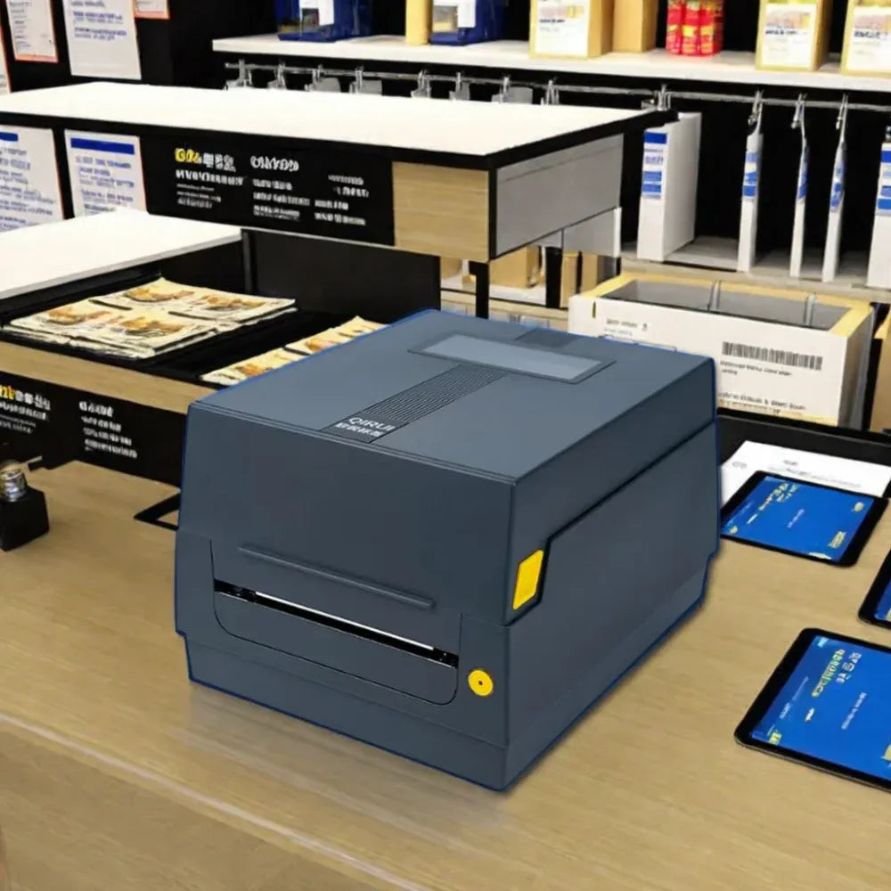 Gray desktop barcode label printer on a counter with front label output