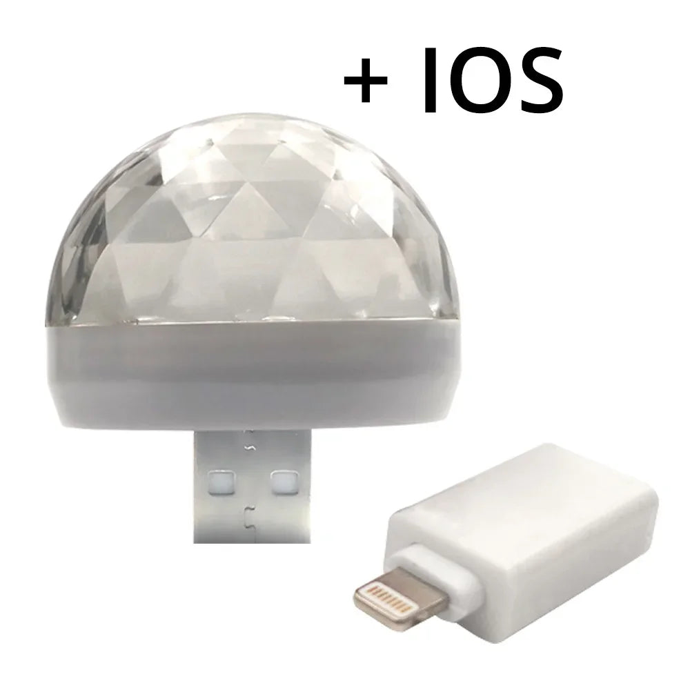 Clear faceted disco ball USB light with a white Lightning adapter for iPhone connectivity.