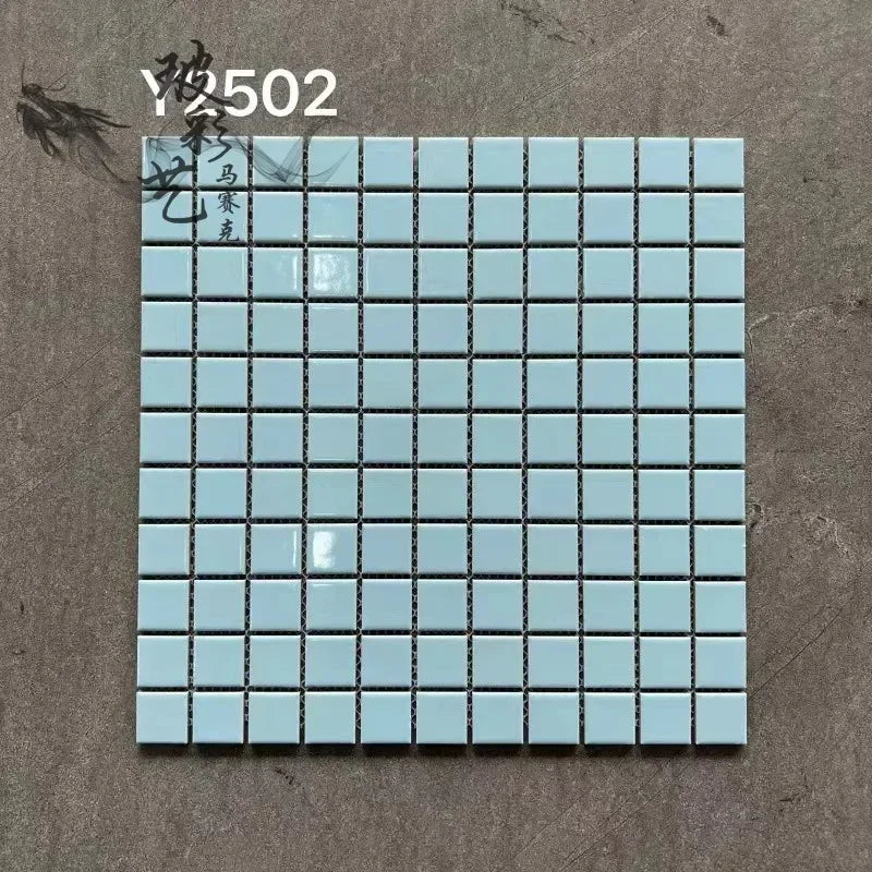 Ceramic mosaic tile sheet with pale aqua squares and dark grout lines